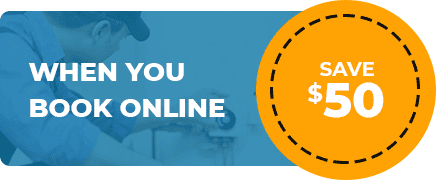Image depicts a promotional offer. On the left, a Sydney plumber wearing a cap is working on an appliance with the text "WHEN YOU BOOK ONLINE" in white. On the right, a bright yellow circle with dashed border contains the text "SAVE $50" in white and orange.
