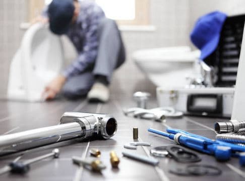 Plumber fixing bathroom