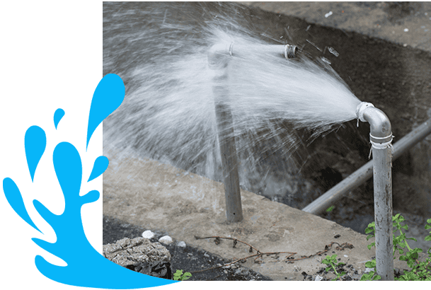 A broken water pipe spraying a strong stream of water onto a paved surface. A blue splash graphic is included in the corner of the image. The surrounding area is slightly wet with some greenery visible in the bottom right corner, making it clear why you might need a Sydney emergency plumber.