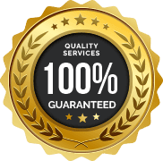 A gold-colored emblem with laurel leaves surrounding it. The center of the emblem has a black circle with white text that reads "QUALITY SERVICES 100% GUARANTEED." Stars adorn the top and bottom of the emblem, representing trusted plumber services in Sydney.
