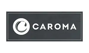 A black rectangular logo with a white circle on the left containing a white crescent-like swirl with a tear-shaped drop. The word "CAROMA" is written in bold white capital letters to the right of the circle, emphasizing quality that top plumbers in Sydney trust. A thin white border outlines the rectangle.
