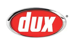 The image shows the "dux" logo, which features the word "dux" in bold white letters on a red oval background. Known among Sydney plumbers for quality, the entire design is framed by a silver metallic border.